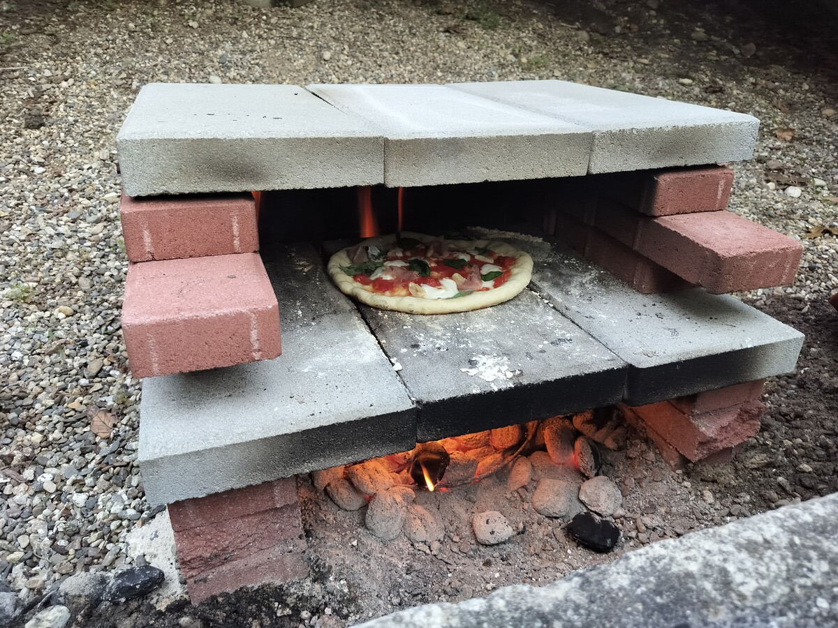 Completed pizza oven with a pizza cooking